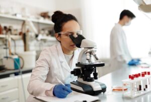 A scientist looks through a microscope in a laboratory