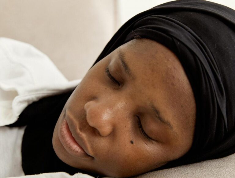Person with a headscarf sleeping