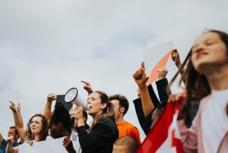 A group of protestors outdoors with a bullhorn