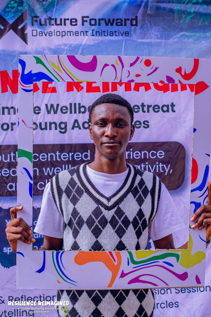 Picture of a young black man holding a photo frame around him